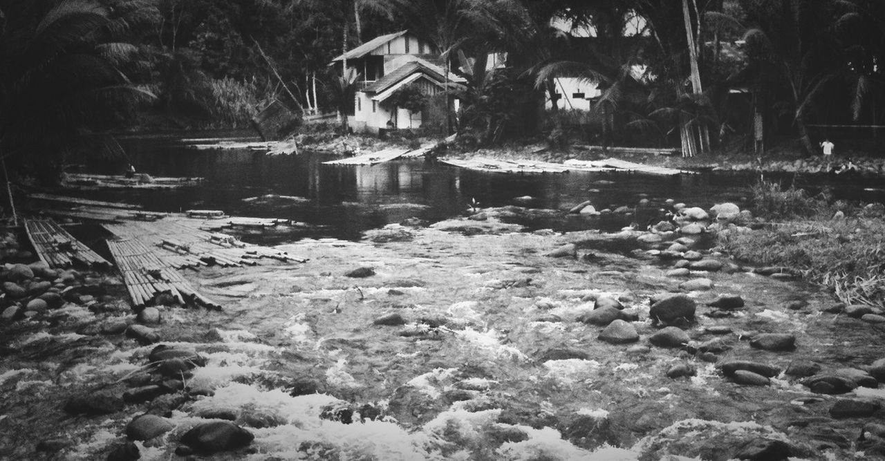 water, built structure, architecture, building exterior, tree, house, nature, reflection, river, waterfront, day, outdoors, no people, rock - object, tranquility, plant, flowing water, lake, residential structure, scenics