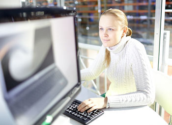 Beautiful businesswoman using computer at office