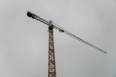 Low angle view of crane against sky