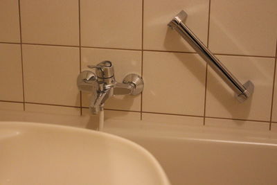 Close-up of faucet in bathroom