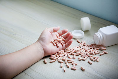High angle view of hand holding food on table
