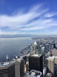 High angle view of buildings by sea against sky