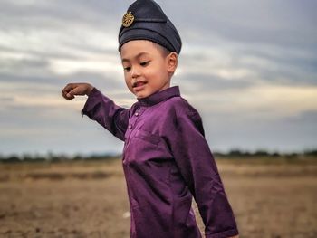 Portrait of boy standing on field