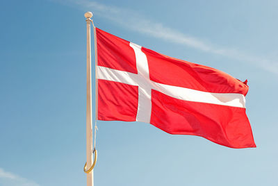 Low angle view of danish flag against sky