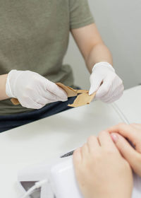 Midsection of doctor examining patient