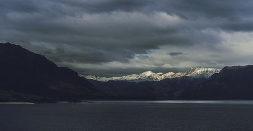 Scenic view of mountains against cloudy sky