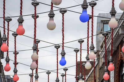 Low angle view of lanterns hanging on cable
