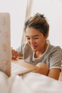 Young woman using laptop at home
