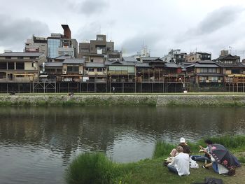 Buildings in city against cloudy sky