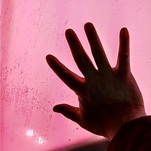 Close-up of hand on wet glass