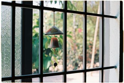 Wind chime hanging from window