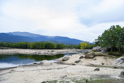 Scenic view of lake and mountains against sky