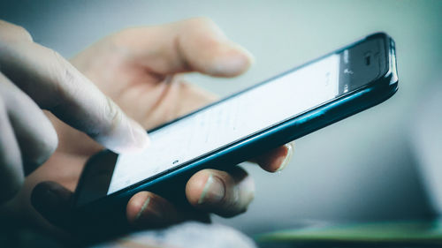 Close-up of man using mobile phone