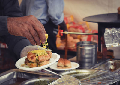 Midsection of man preparing food