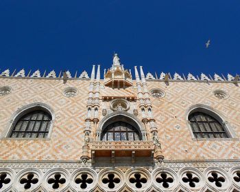 Low angle view of building against blue sky