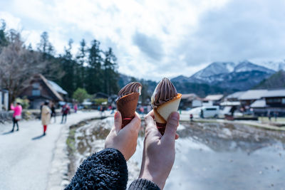Cropped hands of people holding ice cream cones