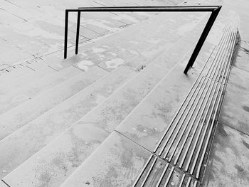 High angle view of empty bench on footpath