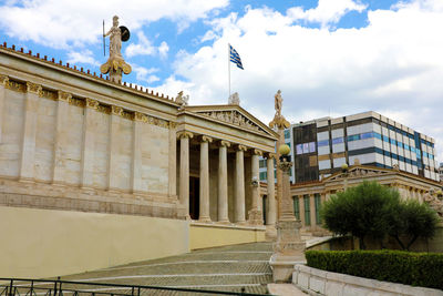 Low angle view of building against cloudy sky