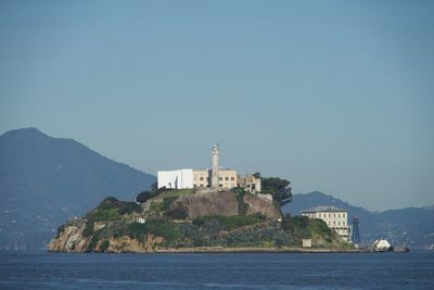 Lighthouse on building by sea