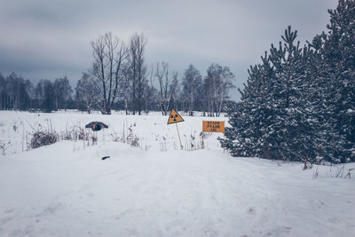 Snow covered field against sky