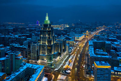 High angle view of city lit up at night