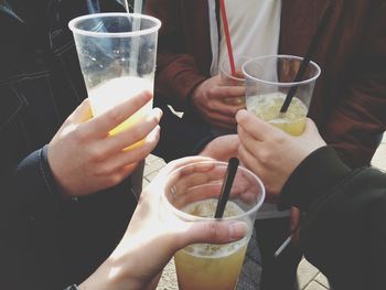 Close-up of hand holding beer glass
