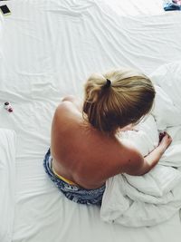 High angle view of woman sleeping on bed at home