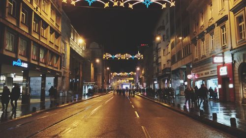 People on road in city at night