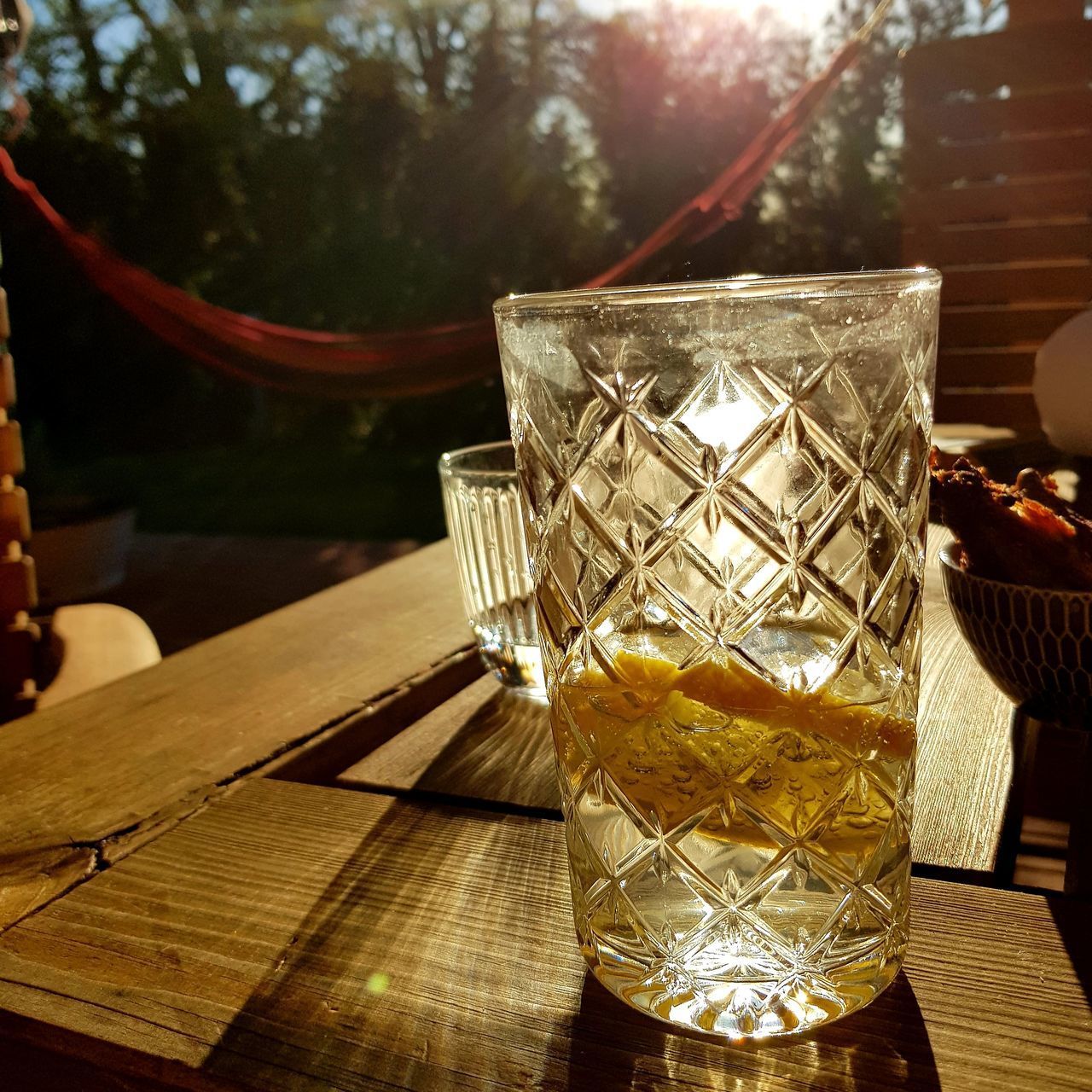 CLOSE-UP OF WINE GLASS ON TABLE AGAINST ICE