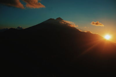 Scenic view of silhouette mountains against sky during sunset