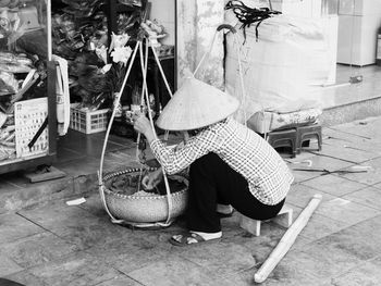 Rear view of woman working in basket