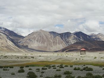 Scenic view of mountains against cloudy sky