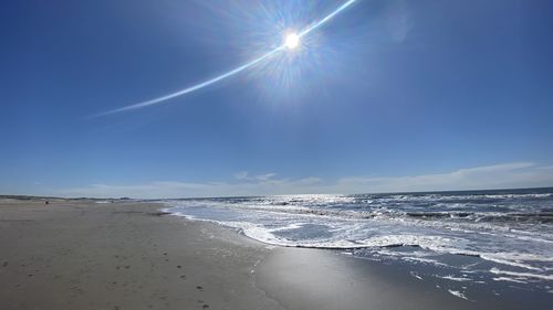 Scenic view of sea against sky on sunny day
