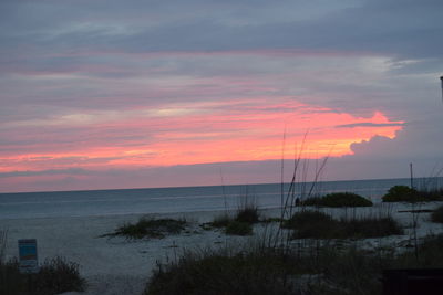 Scenic view of sea against romantic sky at sunset