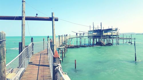 Pier over sea against clear sky