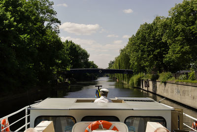 Rear view of sailor in boat on canal