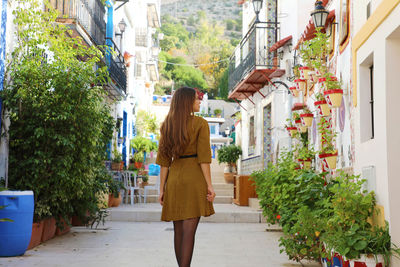 Full length rear view of woman walking in city