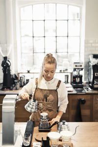 Woman holding coffee in cafe