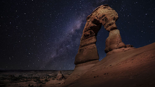 Rock formations against sky at night