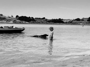 Side view of man on beach against sky