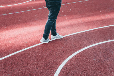 Low section of person running on road