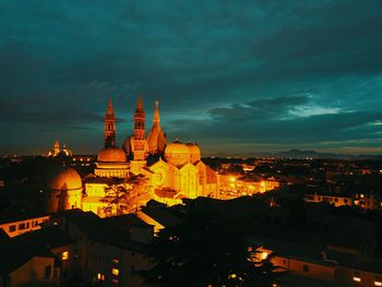 Illuminated buildings in city at dusk