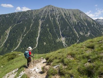 Woman standing on mountain against sky