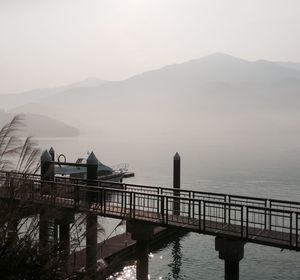 Bridge on sea during foggy weather