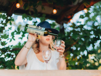 Midsection of a woman drinking glass