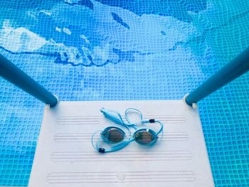 High angle view of pen on table by swimming pool