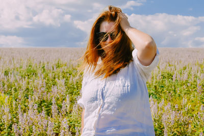 Side view of woman standing on field