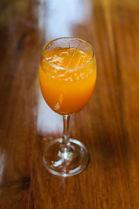 Close-up of orange juice glass on table