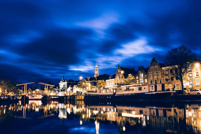 Reflection of buildings in water at night