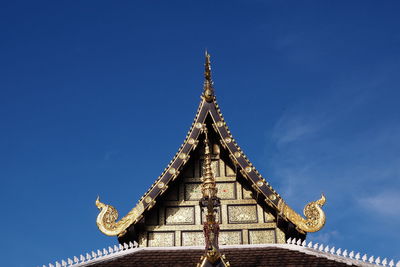 Low angle view of traditional building against blue sky